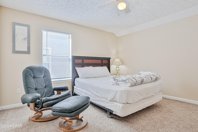 carpeted bedroom featuring ceiling fan, multiple windows, a textured ceiling, and vaulted ceiling