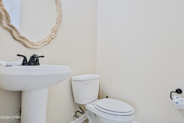 bathroom featuring sink and toilet