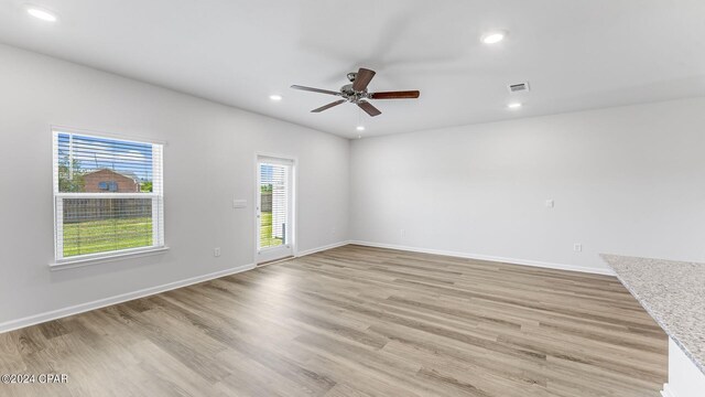 spare room with light hardwood / wood-style floors and ceiling fan