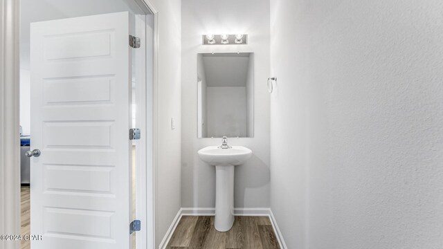 bathroom with hardwood / wood-style floors