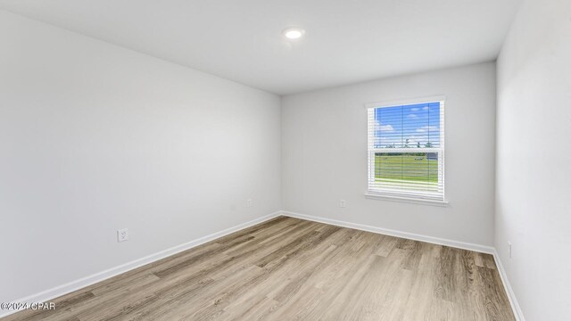 unfurnished room with light wood-type flooring