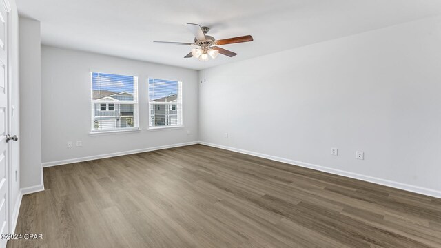 unfurnished room with ceiling fan and wood-type flooring