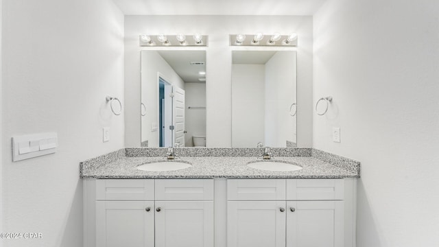 bathroom featuring vanity and toilet