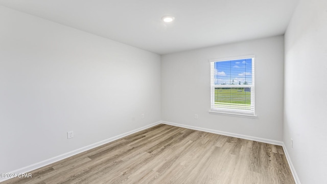 unfurnished room with light hardwood / wood-style floors