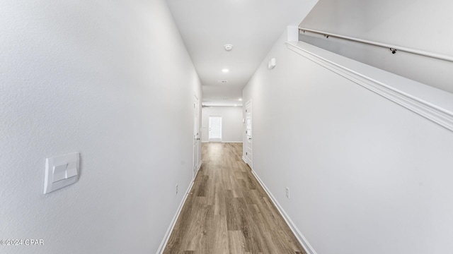 corridor with light hardwood / wood-style floors