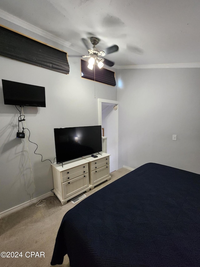 unfurnished bedroom featuring ceiling fan, crown molding, and light carpet