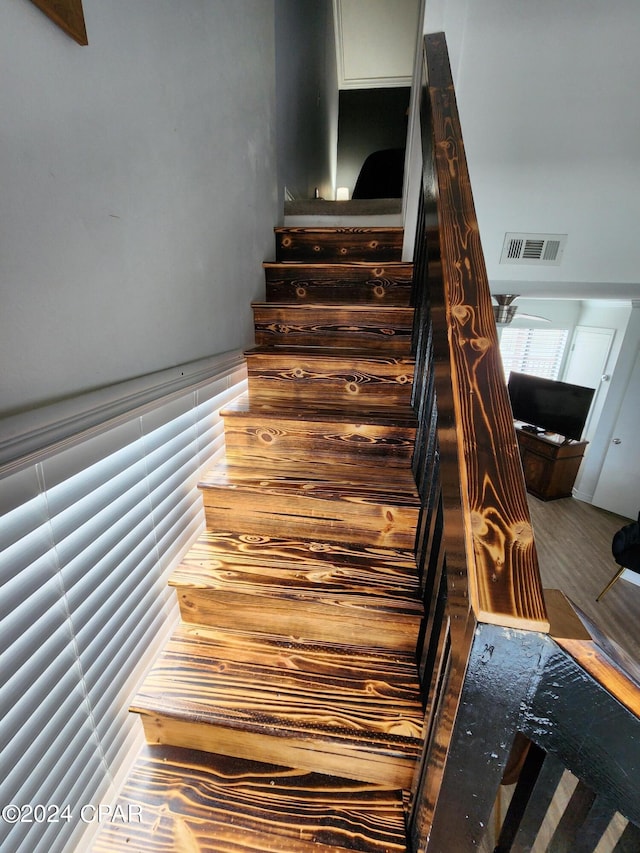 stairway with wood-type flooring