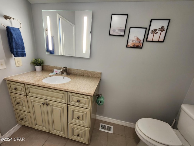 bathroom with tile patterned floors, vanity, and toilet