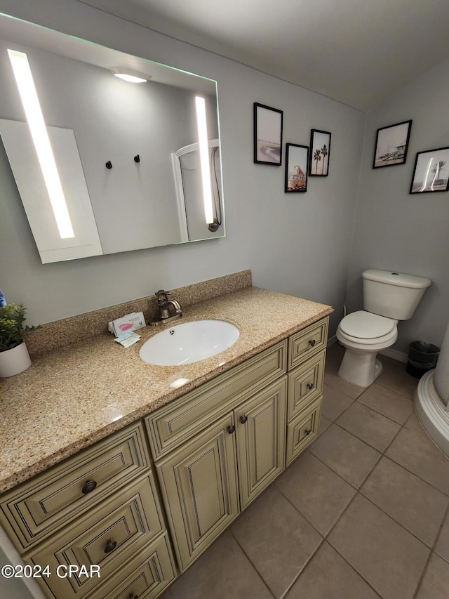 bathroom with tile patterned flooring, vanity, and toilet