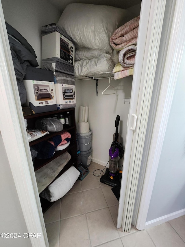 walk in closet featuring light tile patterned flooring