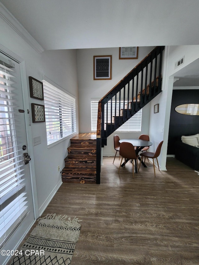 entryway with dark hardwood / wood-style flooring and ornamental molding