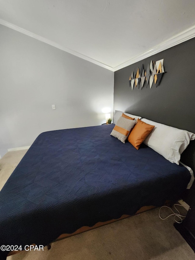 carpeted bedroom with ornamental molding