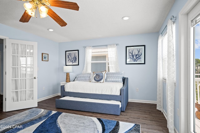 bedroom featuring multiple windows, a textured ceiling, dark hardwood / wood-style flooring, and ceiling fan