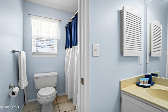 bathroom with vanity, a textured ceiling, radiator, toilet, and tile patterned floors