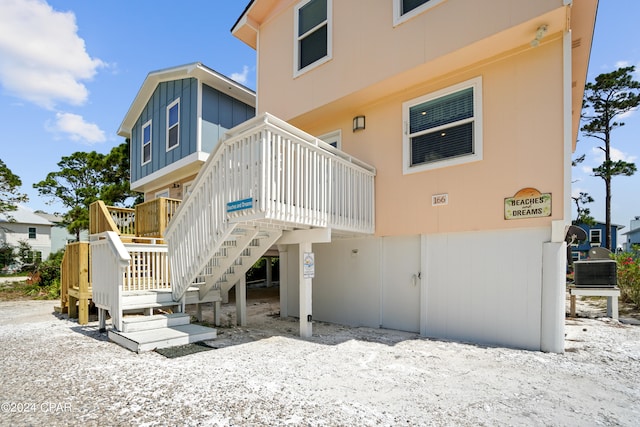 rear view of property featuring a wooden deck