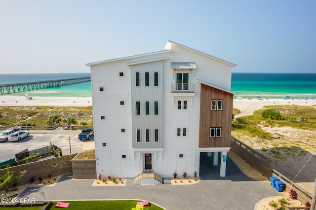 view of property featuring a view of the beach and a water view