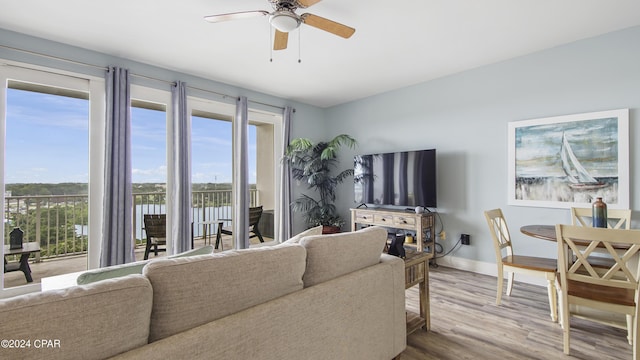 living room with hardwood / wood-style floors and ceiling fan