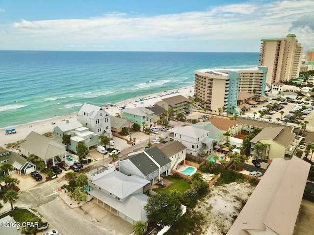 birds eye view of property featuring a water view and a beach view