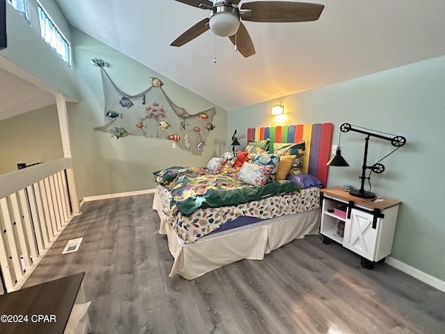 bedroom featuring dark hardwood / wood-style flooring, vaulted ceiling, and ceiling fan