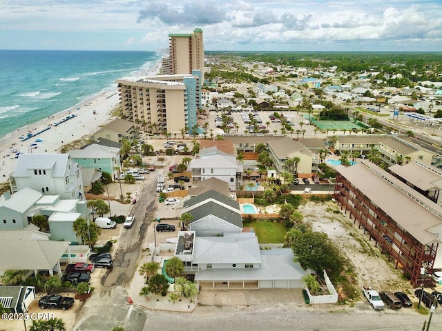 drone / aerial view featuring a water view and a view of the beach