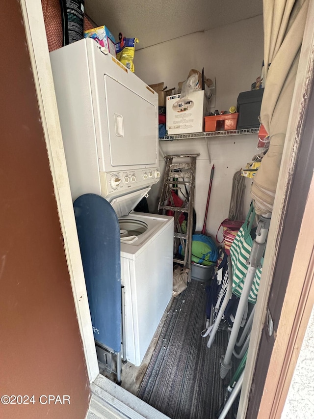 laundry room with stacked washing maching and dryer