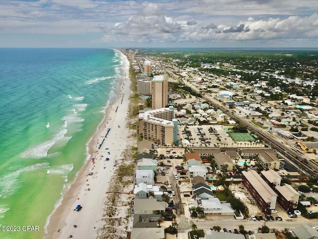 drone / aerial view featuring a water view and a beach view