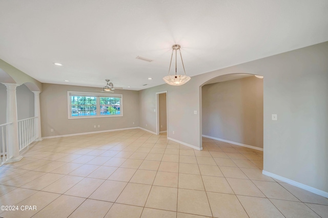 spare room with ceiling fan and light tile patterned flooring