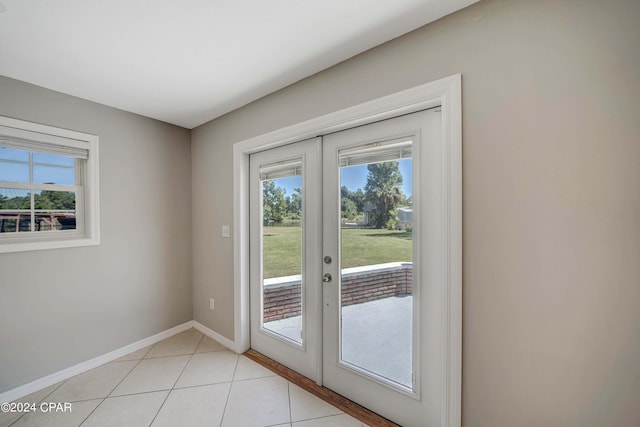 doorway with light tile patterned flooring and french doors