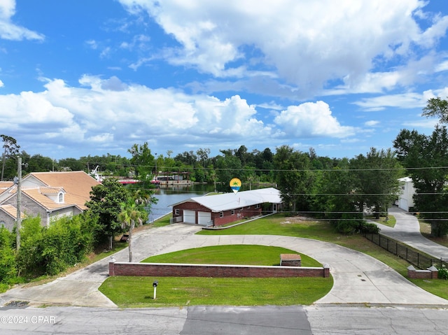 view of property's community featuring a yard and a water view