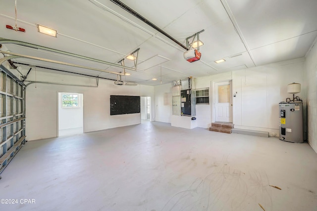 garage featuring electric water heater, heating unit, and a garage door opener