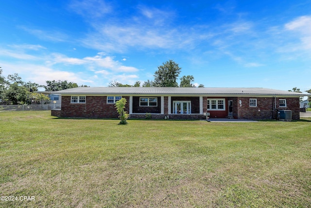 single story home with central AC, french doors, and a front lawn