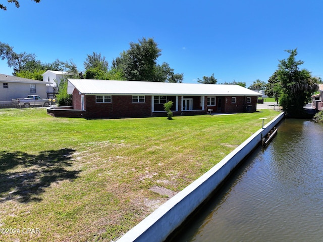 view of front of house featuring a front yard and a water view