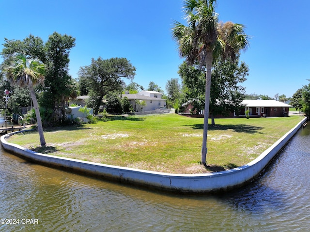 exterior space featuring a yard and a water view