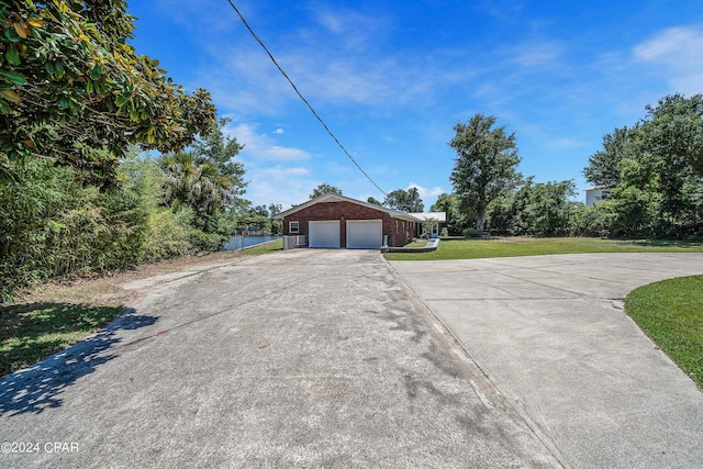 exterior space with a garage and a yard