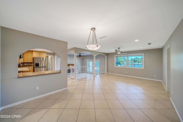 interior space with ceiling fan, light tile patterned floors, and sink