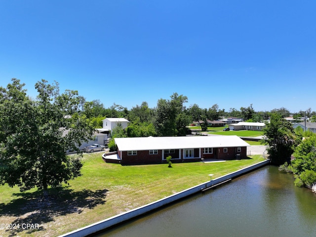 exterior space with a water view and a front lawn