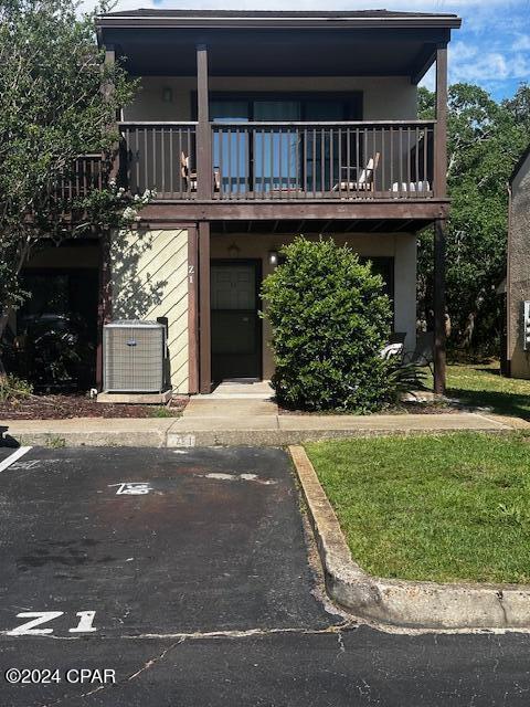 view of front of house with a balcony and central air condition unit