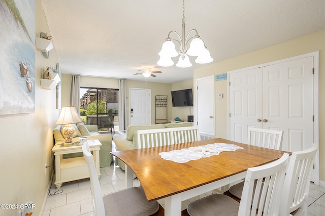 dining space featuring ceiling fan with notable chandelier and light tile patterned floors