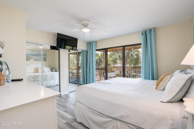 bedroom featuring light hardwood / wood-style flooring, a textured ceiling, ceiling fan, and access to exterior