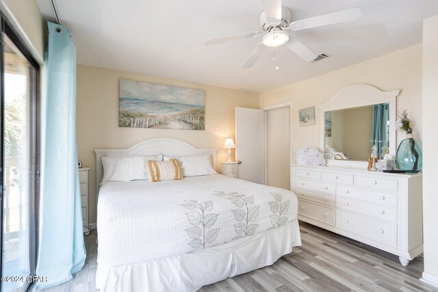 bedroom featuring light wood-type flooring and ceiling fan