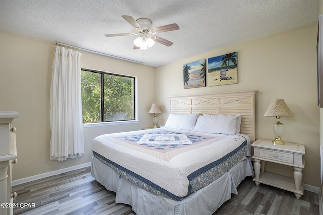 bedroom featuring a textured ceiling, ceiling fan, and hardwood / wood-style floors