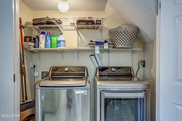 clothes washing area featuring washer and dryer and a textured ceiling