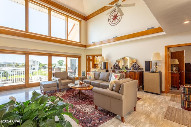 living room featuring ceiling fan and a high ceiling