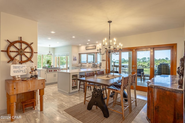 dining room with french doors, an inviting chandelier, plenty of natural light, and sink