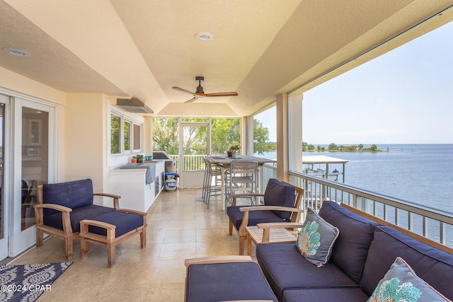 view of patio / terrace with outdoor lounge area, a water view, and ceiling fan