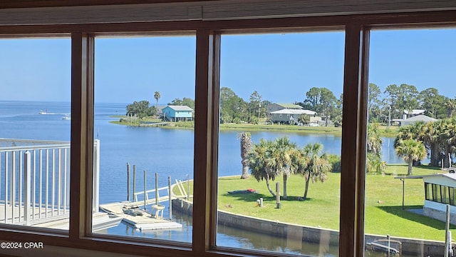 doorway featuring a water view and a healthy amount of sunlight