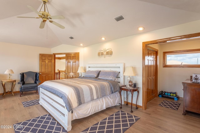 bedroom with ceiling fan, lofted ceiling, and light hardwood / wood-style flooring