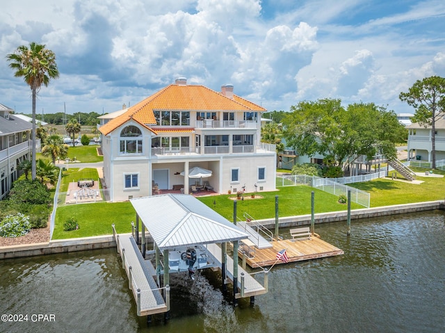 dock area featuring a yard, a balcony, and a water view