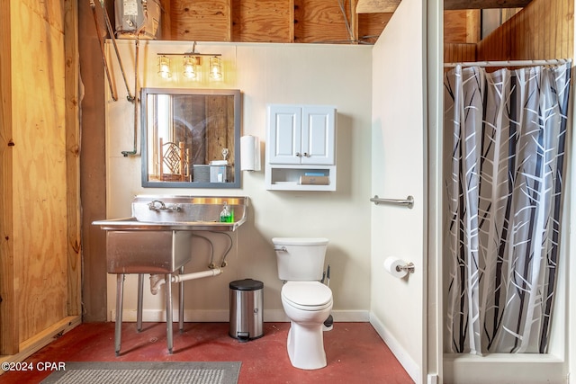 bathroom with a shower with shower curtain and toilet