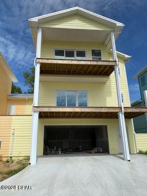 view of front of home featuring an attached garage and concrete driveway